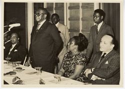 President William V. S. Tubman stands to formally speak at table with Mrs. Tubman, Vice President William Tolbert, and officials
