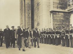 President William V. S. Tubman and others walk together while men in uniform stand at attention at the Tomb of the Unknown Solider at the Arc de Triomphe