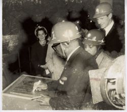 President William V. S. Tubman marks document while at construction site