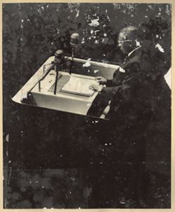 President William V. S. Tubman reads from book at podium