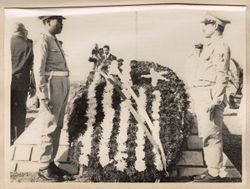 Soldiers stand at attention on either side of wreath on the Monument of the martyrs of Sejoumi