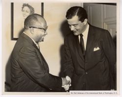 Mr. Earl Anderson of the International Bank of Washington, D.C. shakes hands with another