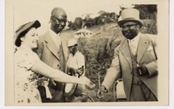 Vice President William R. Tolbert, Jr. greets woman and  official