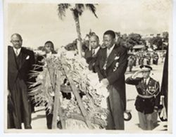 President William V. S. Tubman and associates pay their respects at a memorial wreath during military ceremony