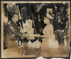 President Tubman hands a scroll to a dignitary