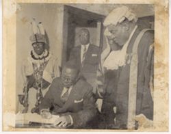 President William V. S. Tubman signs a book