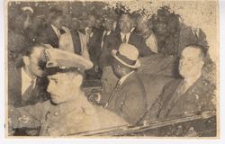 President Tubman seated in back of vehicle with large crowd in background