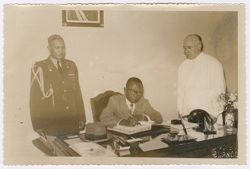 President Tubman  accompanied by General R.A. Brewer signs a book in Spain