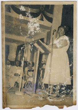 Woman speaks to crowd from behind a lectern