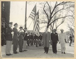 President William V. S. Tumban and Dr. Normal Auburn pass ROTC honor guard en route to Memorial Hall