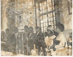 President Tubman stands at the microphone while Mrs. Tubman and party look on