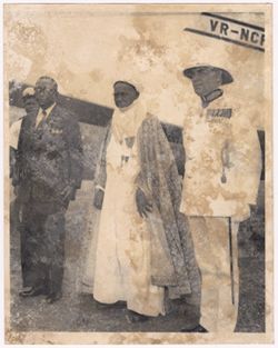 President William V. S. Tubman poses with dignitaries in front of an airplane