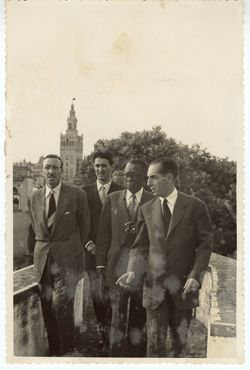 President Tubman and other dignitaries on a walkway with the Seville Cathedral in the background