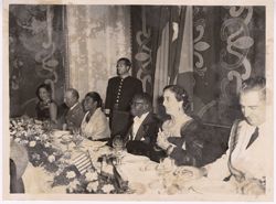 Side shot of Carmen Polo, President and Mrs. Tubman, and General Franco seated at formal dinner