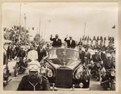 President Tubman and President Bourguiba waving to the cheering crowd