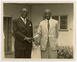 President William V. S. Tubman poses while shaking hand with another man