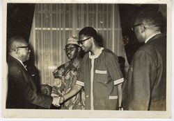 President William V. S. Tubman greets men in traditional dress during reception