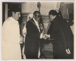 President William V. S. Tubman shakes hands with a dignitary