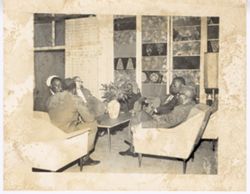 Group sits together in chairs