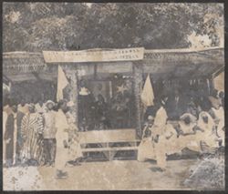 Dignitaries sit on an outdoor dais