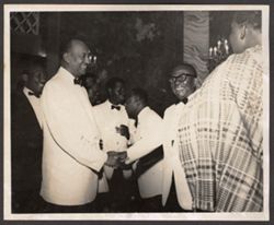 President William V. S. Tubman shakes hands with a dignitary