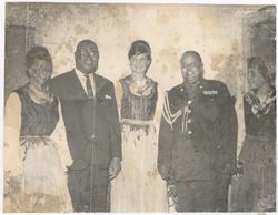 Austrian woman stand with military personnel and official
