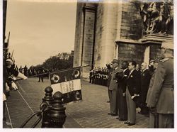 President William V. S. Tubman and others salute flag that states Republique Francaise Garde Republicaine de Paris