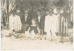 President William V. S. Tubman stands with guests at  head dinner table during formal event