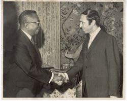 President William V. S. Tubman shakes hands with man