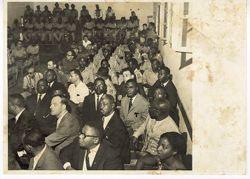 Military officials and guests sit during a memorial service