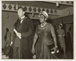 Mrs. Tubman walks with man in commencement attire