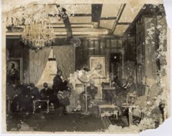 Officials sitting around in formal sitting room for a meeting
