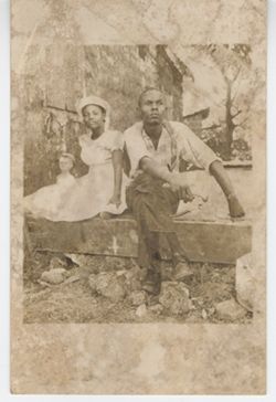 Young man and young woman pose outdoors