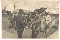 President William V. S. Tubman shakes hand of man as he leaves airplane