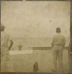 Men stand on dock and look out on water