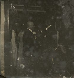 Group in formal dress gather during reception