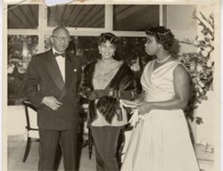 Ambassador stands with Mrs. Brewer and Mrs. Reeves-Gorgla during formal reception