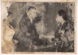 Guests shake hands at a party