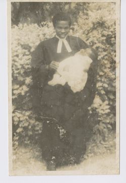 Man holding baby on formal occasion