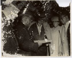 President William V. S. Tubman hands box to fellow officials