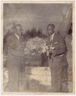 President William V. S. Tubman and another official hold flowers