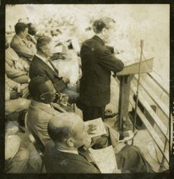 Dignitary speaks into a microphone from behind a lectern