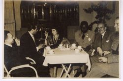 Dignitaries talk while seated at a table