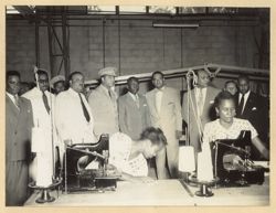 President William V. S. Tubman stands with group during factory tour
