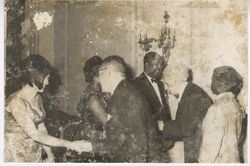 Guests mingle with one another at a formal event