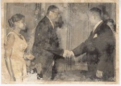 Couple greeting man in reception line