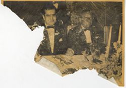 Man and President William V. S. Tubman sit together at table