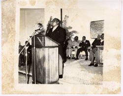 Vice President Tolbert stands at podium and speaks