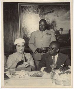 Israeli Foreign Minister Golda Meir opens gift presented by President William V. S. Tubman during her visit to Liberia