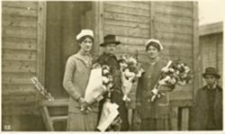 Three women holding flowers